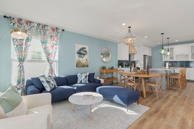 living room featuring light hardwood / wood-style flooring and a chandelier