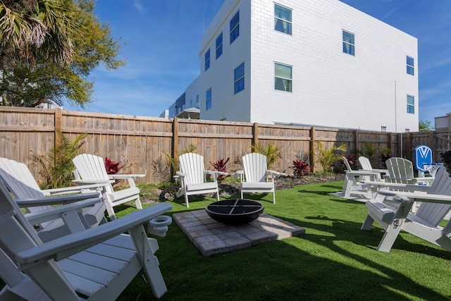 view of yard featuring an outdoor fire pit