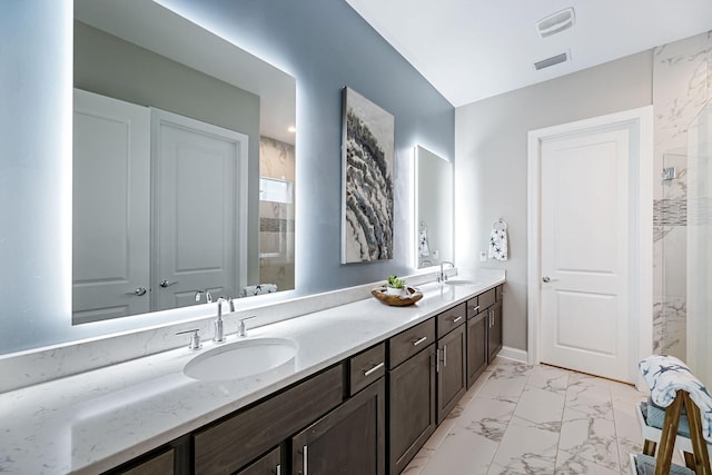 bathroom featuring a shower and vanity