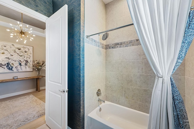 bathroom featuring shower / bathtub combination with curtain, wood-type flooring, and a notable chandelier