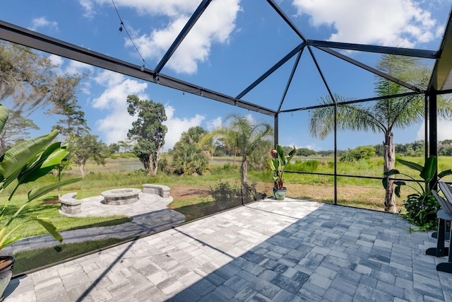 view of patio / terrace featuring an outdoor fire pit and a lanai