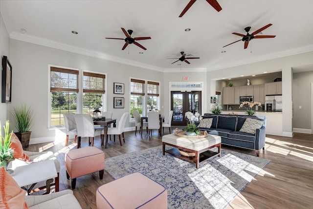 living room with french doors, dark hardwood / wood-style flooring, a wealth of natural light, and ornamental molding