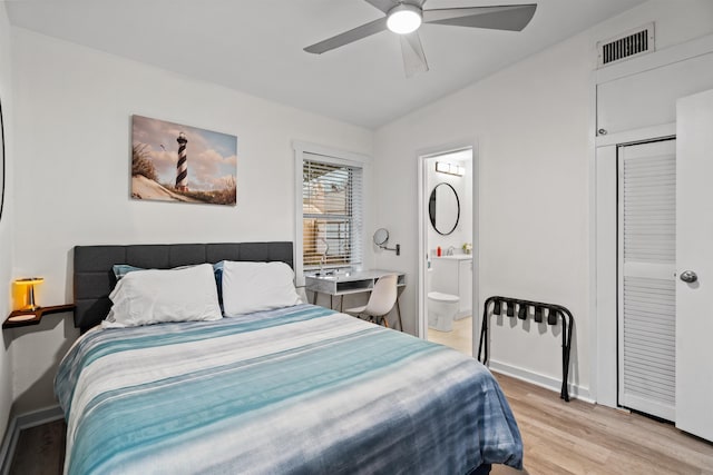 bedroom with lofted ceiling, light hardwood / wood-style flooring, ceiling fan, and ensuite bathroom