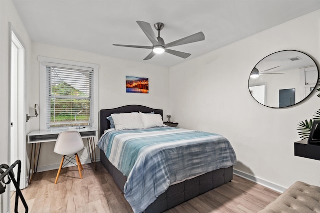 bedroom with wood-type flooring and ceiling fan