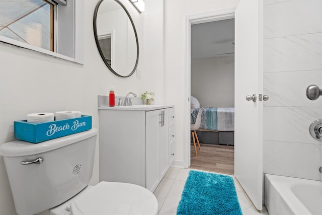 bathroom with vanity, tile patterned flooring, and toilet