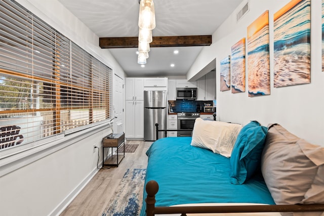 bedroom with stainless steel refrigerator, lofted ceiling with beams, and light hardwood / wood-style flooring