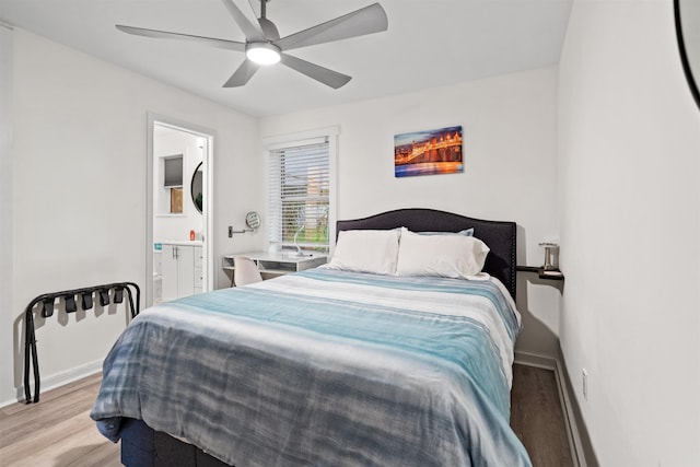 bedroom with ceiling fan, ensuite bath, and light hardwood / wood-style flooring