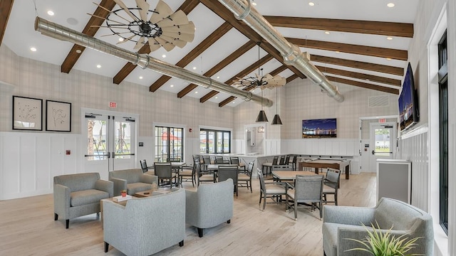 living room with beam ceiling, a healthy amount of sunlight, french doors, and high vaulted ceiling