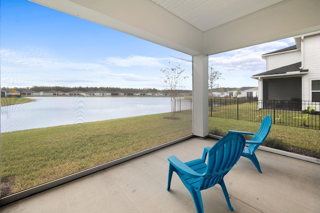 sunroom / solarium featuring a water view