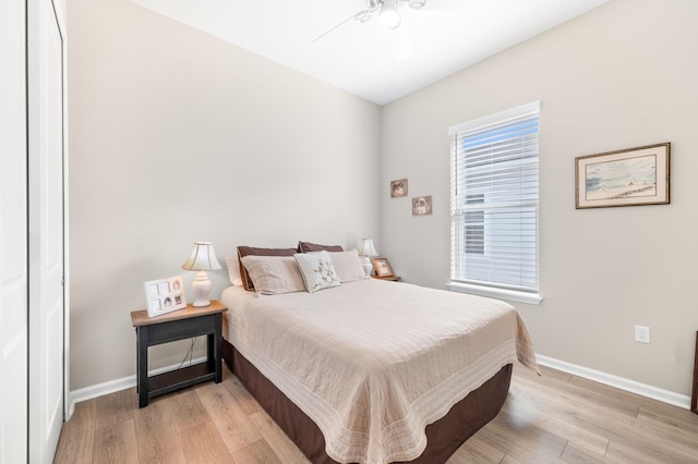 bedroom featuring a closet, ceiling fan, and light wood-type flooring