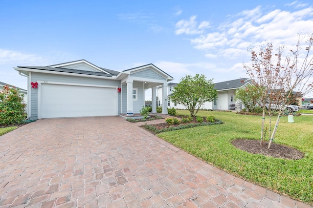 ranch-style home with a front yard and a garage