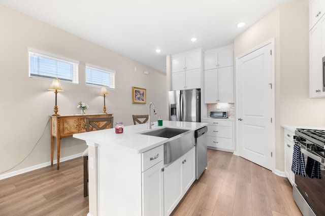 kitchen featuring white cabinetry, a kitchen island with sink, and appliances with stainless steel finishes