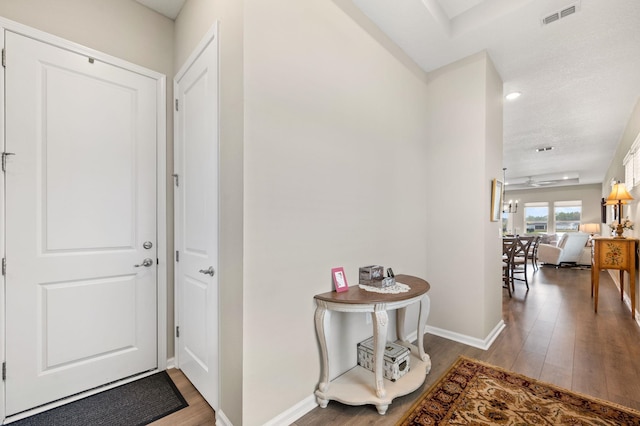 foyer entrance featuring hardwood / wood-style flooring, a textured ceiling, and ceiling fan