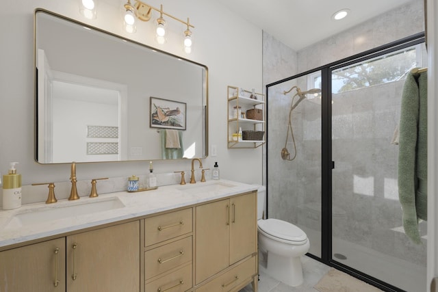 full bathroom featuring a shower stall, toilet, double vanity, and tile patterned floors