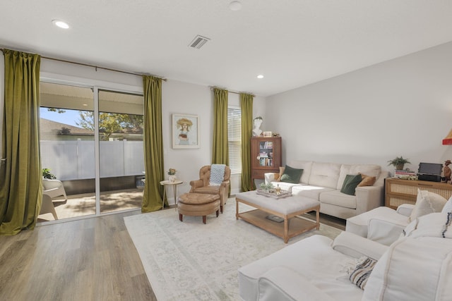 living area with wood finished floors and recessed lighting