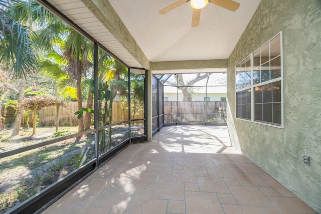 unfurnished sunroom featuring ceiling fan