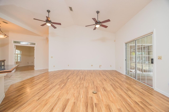 unfurnished room with light wood-type flooring, high vaulted ceiling, baseboards, and visible vents