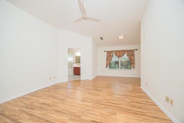 unfurnished living room featuring a ceiling fan, lofted ceiling, baseboards, and light wood finished floors