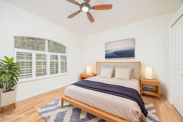 bedroom featuring a ceiling fan, baseboards, and wood finished floors