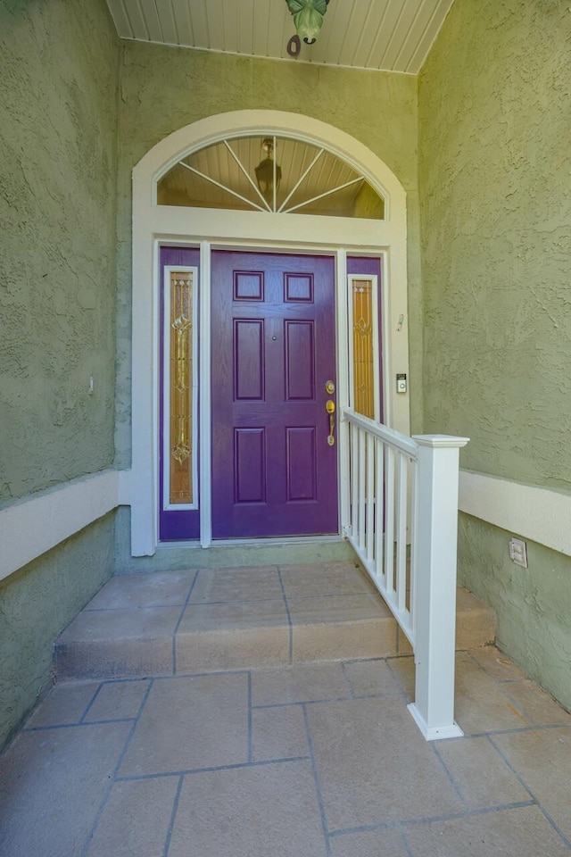 entrance to property featuring stucco siding