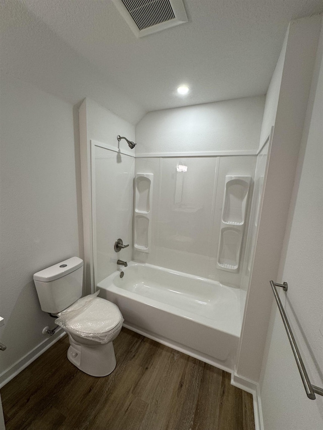 full bath with wood finished floors, visible vents, baseboards, tub / shower combination, and toilet