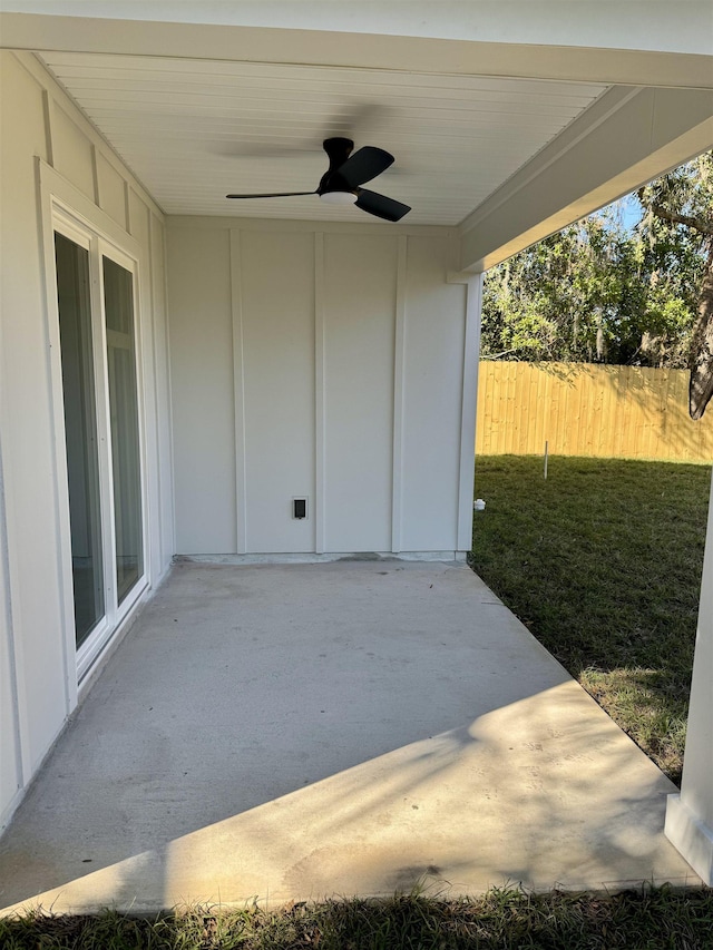 view of patio featuring a ceiling fan and fence