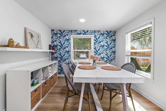 dining room with wallpapered walls, baseboards, and a wealth of natural light