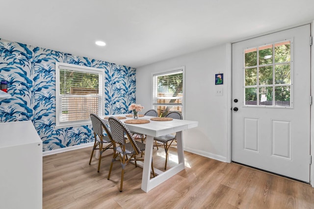 dining room with a wealth of natural light, light wood-style floors, and wallpapered walls