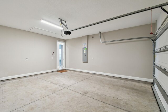 garage with electric panel, baseboards, and a garage door opener
