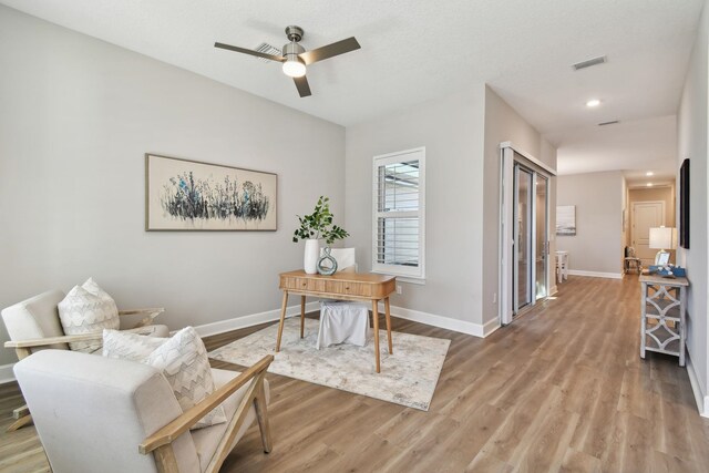 office area with visible vents, baseboards, recessed lighting, light wood-style floors, and a ceiling fan
