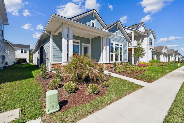 view of front of property with a front lawn, board and batten siding, and a residential view