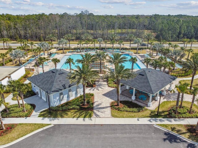 drone / aerial view with a wooded view