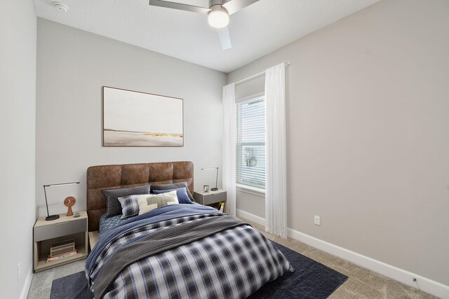 carpeted bedroom featuring a ceiling fan and baseboards