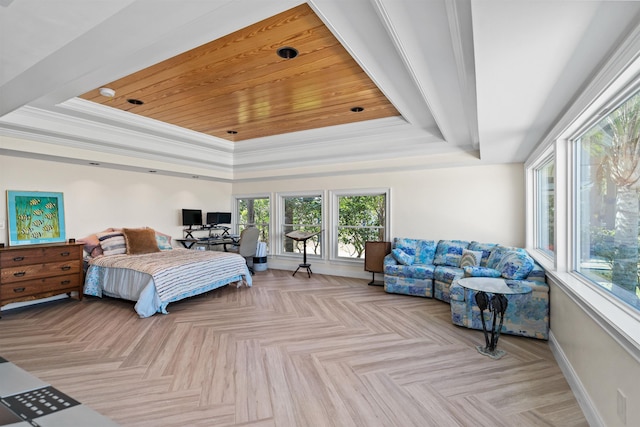 bedroom with crown molding, a tray ceiling, and baseboards