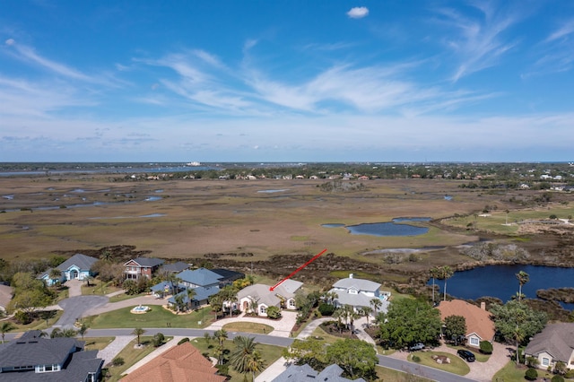 drone / aerial view with a water view and a residential view