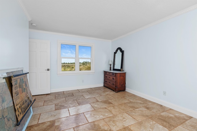 unfurnished living room with ornamental molding, stone finish flooring, and baseboards