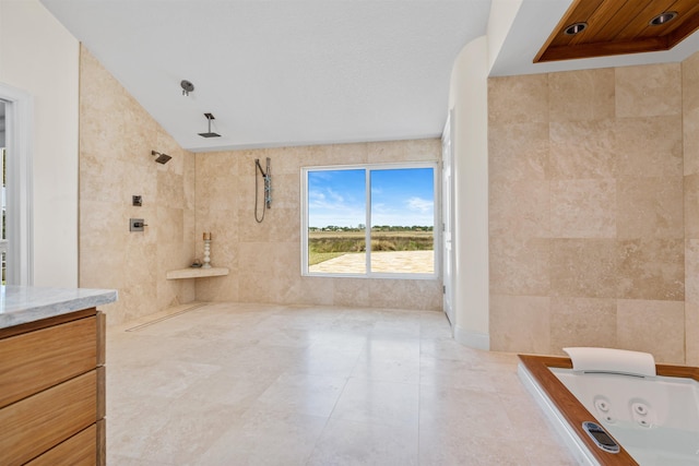 full bathroom with lofted ceiling, vanity, tile walls, a tile shower, and a tub with jets