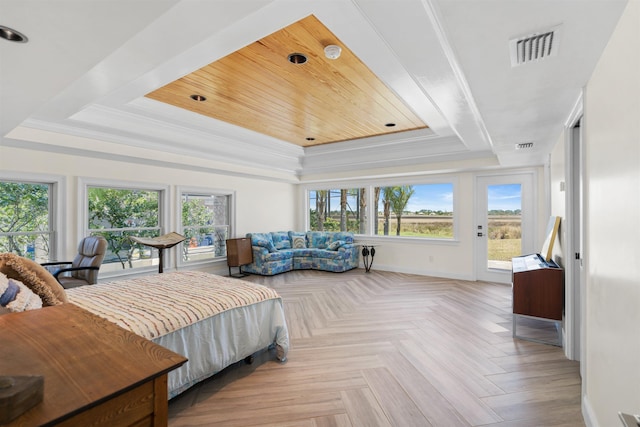 bedroom featuring access to outside, a raised ceiling, visible vents, and multiple windows