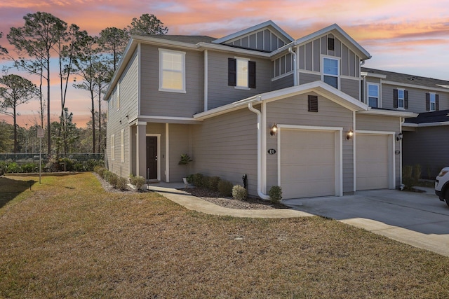 view of front of house with a yard and a garage