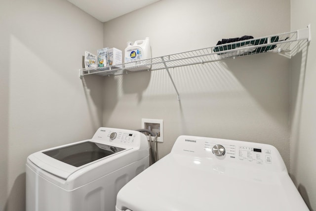 laundry area with independent washer and dryer