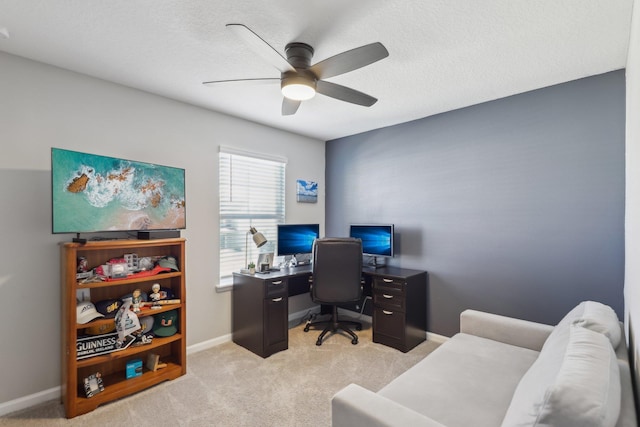 office space with light carpet, a textured ceiling, and ceiling fan