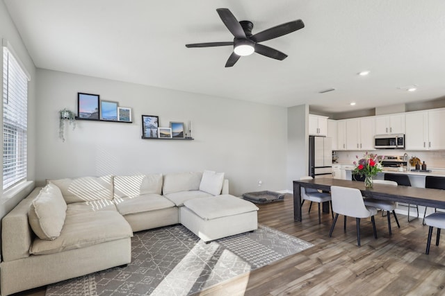 living room with hardwood / wood-style flooring and ceiling fan