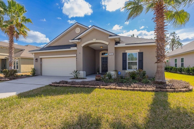 view of front of house with a garage and a front lawn