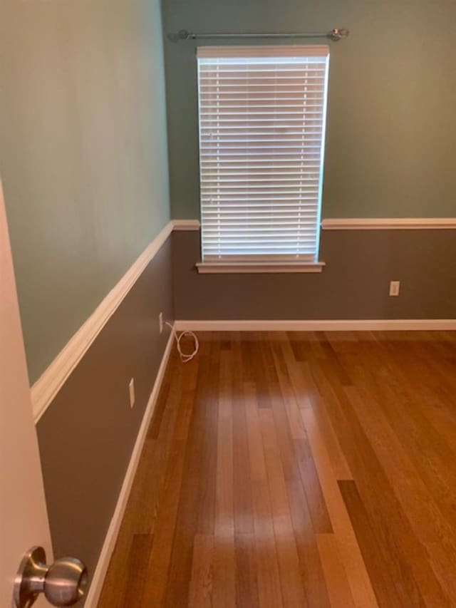 empty room with hardwood / wood-style flooring