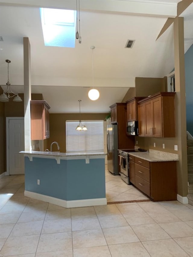 kitchen featuring pendant lighting, high vaulted ceiling, light tile patterned floors, appliances with stainless steel finishes, and a breakfast bar area