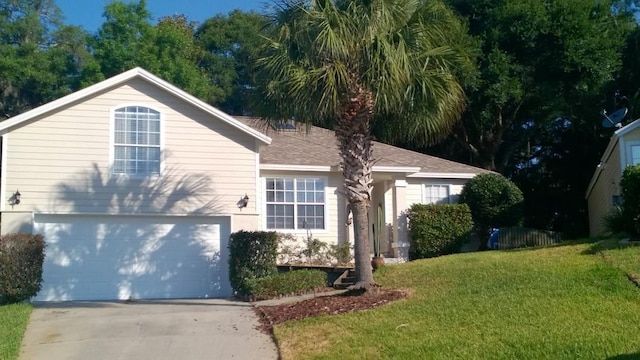 view of front of home with a front yard and a garage