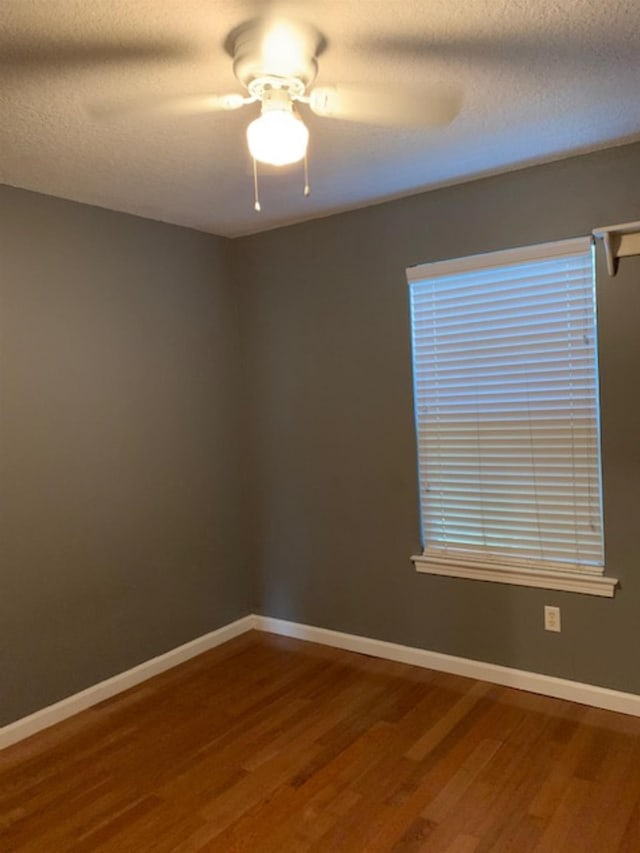 empty room featuring wood-type flooring, a textured ceiling, and ceiling fan