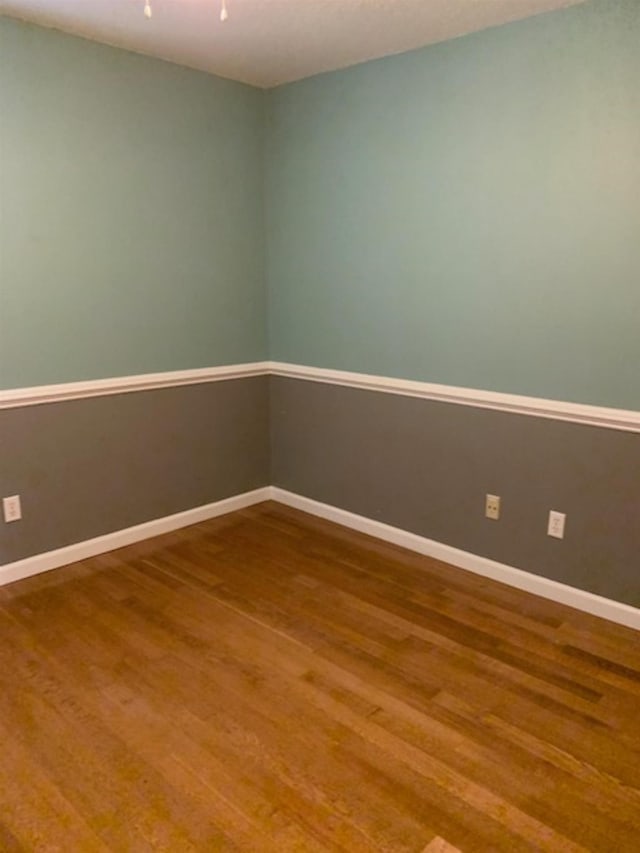 empty room with hardwood / wood-style floors