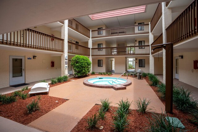 view of pool with a hot tub, a patio area, and exterior kitchen