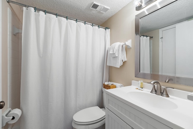 bathroom featuring curtained shower, vanity, a textured ceiling, and toilet